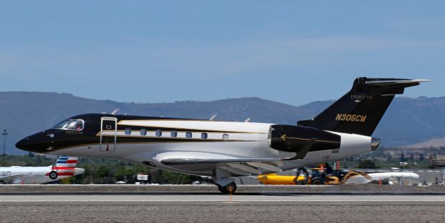 Embraer Legacy 550 (N306CM) - Barely any smoke as this Embraer Legacy touches down on 16L.