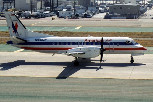 Saab 340 (N330AE) - Taxiing to depart rwy 24L on 25-Jun-02.
