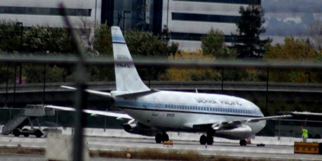 Boeing 737-200 (N703S) - Shot was made from the leveled grounds of the former, San Jose State Aviation, on the West side of the airport. Never seen this one here before, and then it not to park at GA. Was located on the East side of the airport, near the grounds of the former Terminal C