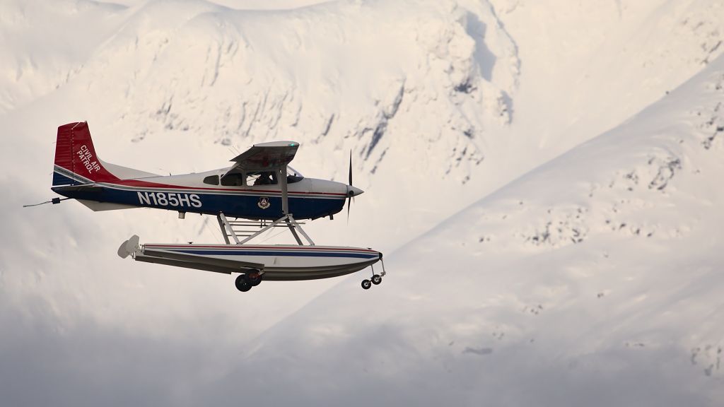 Cessna Skywagon (N185HS) - Walking the dogs on Mendenhall Wetlands, CAP was landing with the mountains (and some sun!) in the background.
