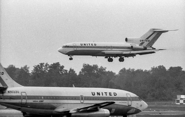 Boeing 727-100 (N7072U) - B727 N7072U delivered to United in 1966 landing at CLE with a very new B737-200 - delivered to United in 1968 - taxiing in the foreground