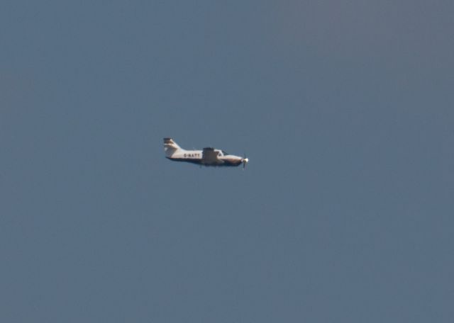Rockwell Commander 114 (G-NATT) - Rockwell Commander 114A (G-NATT) flies overhead.  April 2022.