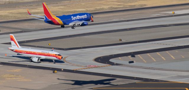 Boeing 737-700 (N7835A) - Although the visual angle of this shot might make it seem that Southwests N7835A is lined up to land on Bravo taxiway, the shadow on the ground gives the true picture .... the SWA fleetbird, arriving from KLAS at 10 AM, is correctly lined up to land on KRNOs 34L as Americans N742PS, dressed in the colorful PSA heritage livery, waits at the 34L HOLD line. 