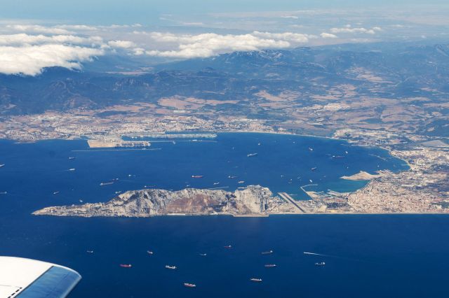 — — - Image taken after take-off from Gibraltar on Falcon 900EX - left turn out from Runway 27 shows great vista of Rock of Gibraltar, Gibraltar Airport with Algiceras Spain under the cloud. We were on route to EGHI.