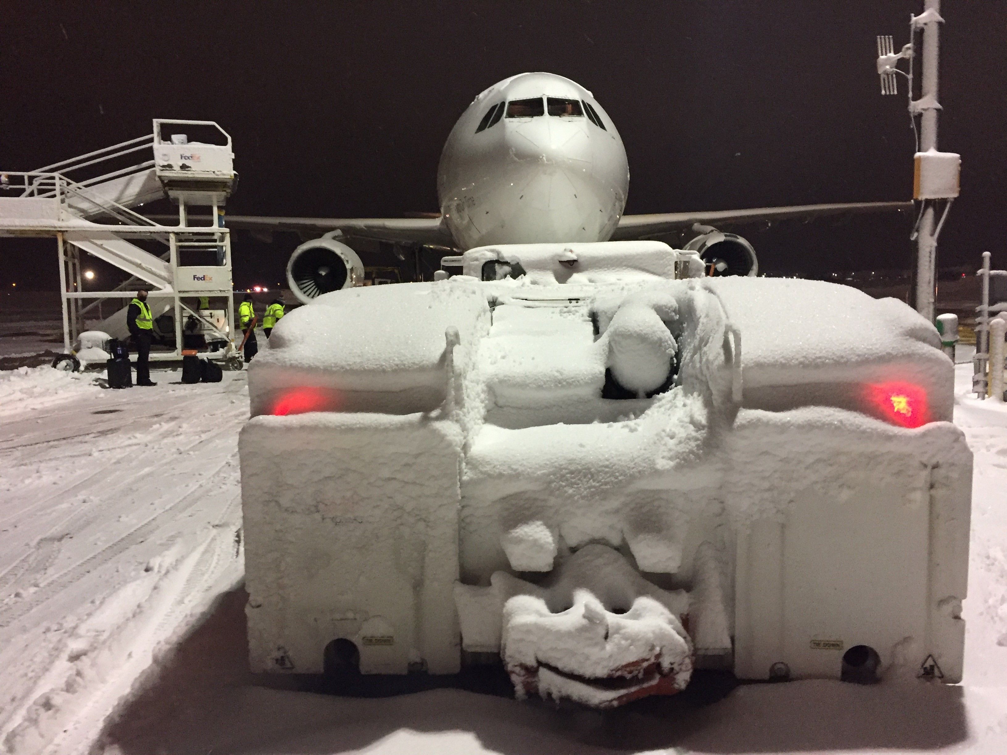 Airbus A300F4-600 (N723FD) - The remnants of last year's February 4th wet heavy snow fall.  The flight crew is patiently waiting for the steps to be mated to A300- 6F "Cody".  The "Push Back" Vehicle heavy with snow. 