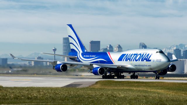 Boeing 747-400 (N952CA) - Left of the tunnel looking west at 35R in Calgary. This B747 took off at 11am.  Lucky to get the city of Calgary in the background