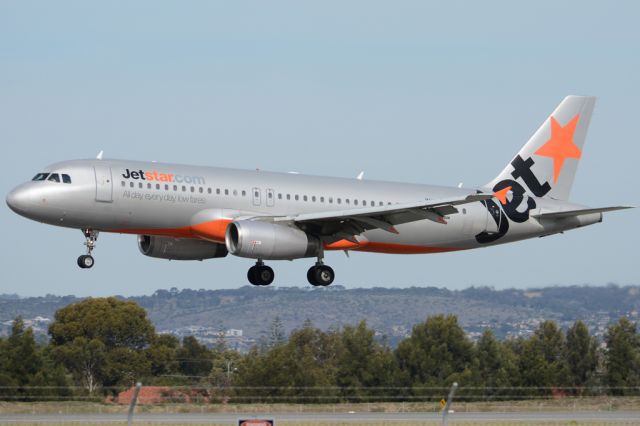 Airbus A320 (VH-VQL) - About to put down on runway 05. Thursday, 8th May 2014.