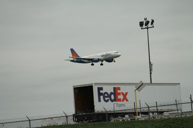 Airbus A320 (N221NV) - Allegiant Air flight 982 from KPGD arriving over the cargo ramp on runway 06.