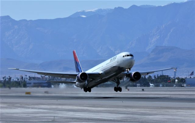 BOEING 767-400 (N828MH) - KLAS - rare for me 7R departures at Las Vegas April 1, 2005 filmed from the E Sunset Ave Airpark. Strong winds this day had most air traffic landing on the 1s and departures from Runway 7LR. I was so glad i had my ladder with me in the back of my F250. Google maps also has a photo section posted under McCarran International Airport Aircraft Viewing Area