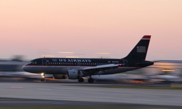 Airbus A319 (N767UW) - Home for the night in Charlotte, North Carolina. This A319 has just landed; engine thrust reversers deployed, spoilers up and brakes applied. Another safe landing.