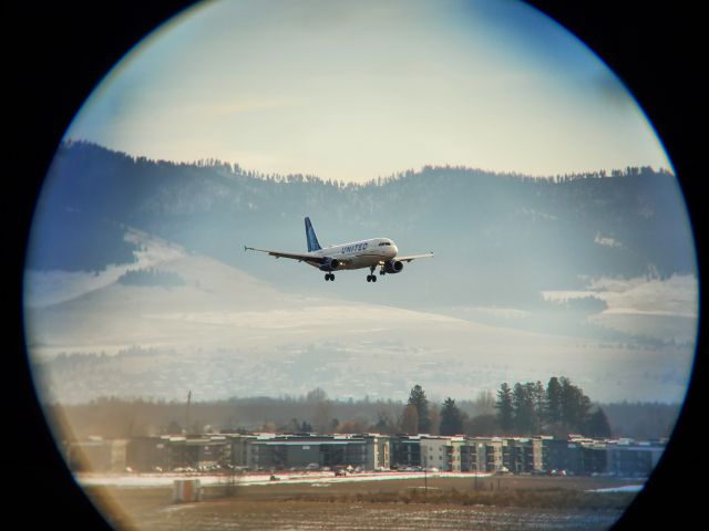 Airbus A320 (N484UA) - United 639 DEN-MSO on 12/27/23. A beautiful high overcast winter day, so I climbed the hangar tower and tried some shots through my binoculars.