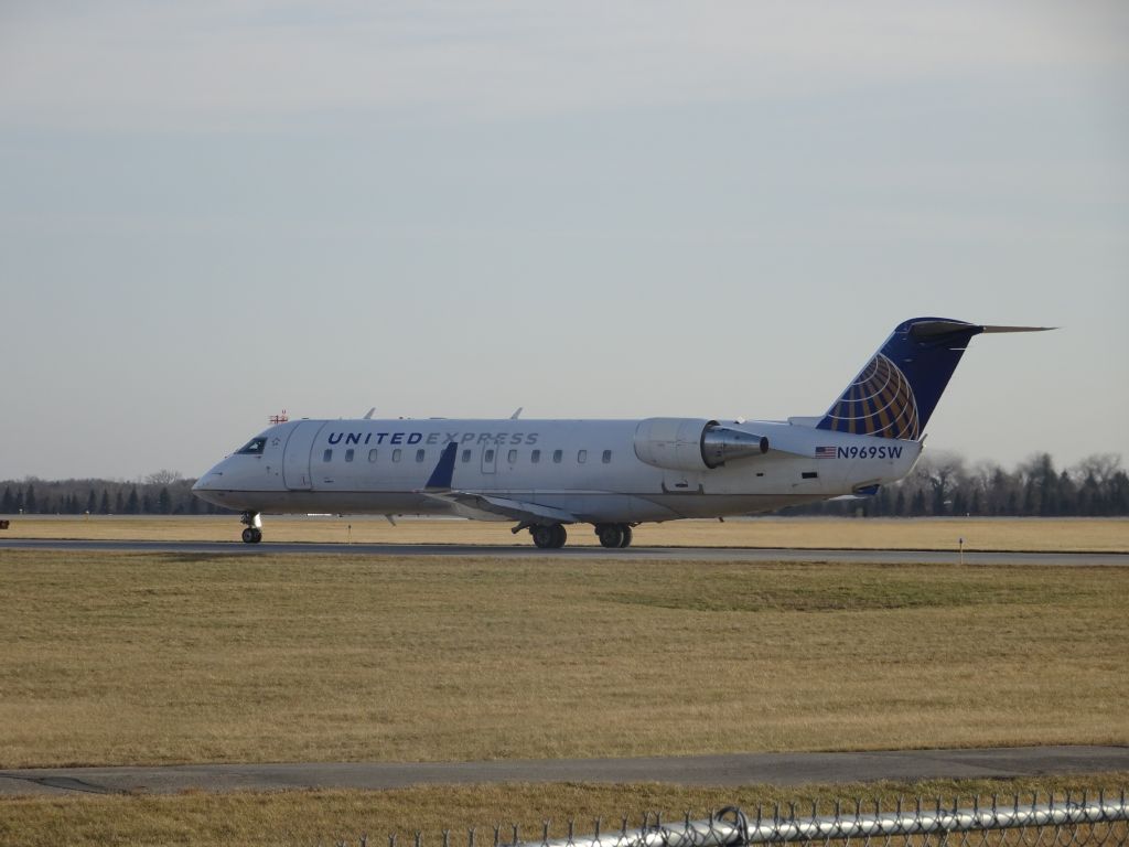 Canadair Regional Jet CRJ-200 (N969SW) - Skywest CRJ-200 taking off to Denver from Fargo. if you look above the engine you car see a small flap open. If you know what it is please tell me.