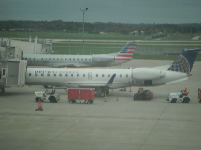 Embraer EMB-145XR (N11164) - New American Eagle livery in background.