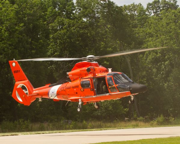 Cessna Skylane (N6591) - The US Coast Guard HH-65C Dolphin creates a small cloud of dust as it lifts off the ramp to depart Become A Pilot Day at the Steven F. Udvar-Hazy National Air and Space Museum