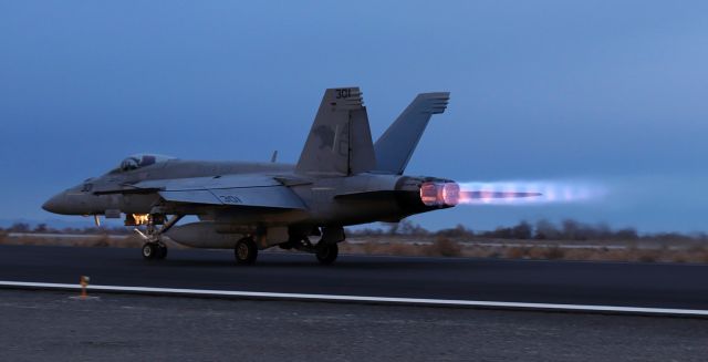 — — - A VFA 131 "Wildcats" F/A-18E Super Bug makes a dusk-hour departure.