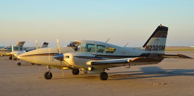 Piper Apache (N2320M) - N2320M seen on the tarmac at KBKL. It is lined up with other aircraft of the same livery. Please look for more photos at Opshots.net