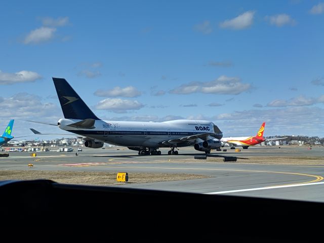 Boeing 747-400 (G-BYGC) - British Airways Boeing 747-400 taxing to the gate in Boston Logan. Painted in retro BOAC livery. Photo taken from the right seat of a Dash-8 Q400 holding on runway 4L at taxiway F.