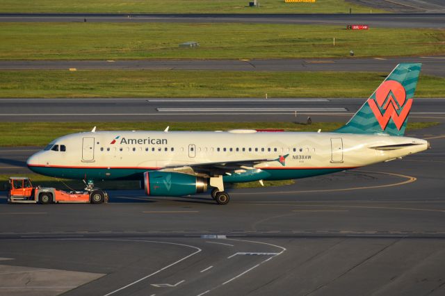 Airbus A319 (N838AW) - American Airlines America West heritage livery being towed past central parking at Boston.