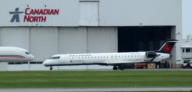 Canadair Regional Jet CRJ-900 (C-FJZL) - Taxiing to parking is this 2016 Air Canada Express Mitsubishi Canadair Regional Jet 900LR in the Spring of 2024.
