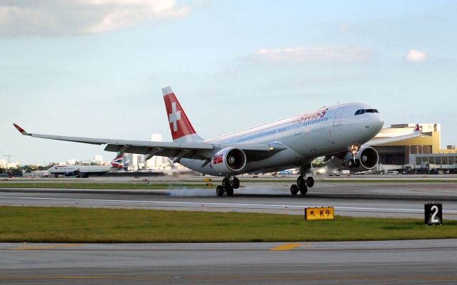 Airbus A330-200 (HB-IQA) - love the "popping a wheelie" effect on main gear touuchdown on R-26R