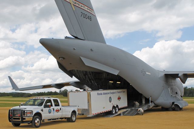 Boeing Globemaster III (97-0048) - Florida Advanced Surgical Transport Team (FAST) and equipment from Miami, Florida, being offloaded from a USAF C-17 Globemaster III, 97-0048, from the 445th Airlift Wing, Wright-Patterson AFB, OH, on 26 Jul 2013. Ft. McCoy and nearby Young Air Assault Strip was host to a joint-services field training and mass casualty exercise-Warrior Exercise 86-13-01 (WAREX).