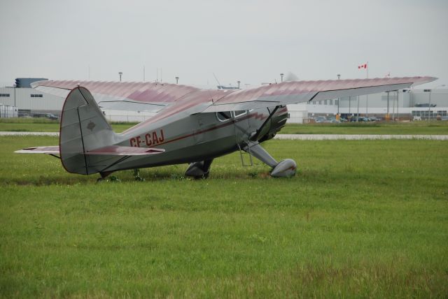 C-FCAJ — - Stinson V77 just completed two year restoration, cutting through the grass to the main runway at Downsview. July 11/08.