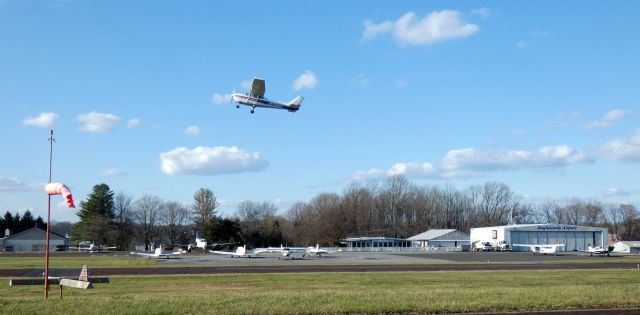 Cessna Skyhawk (N734AU) - Shortly after departure is this 1977 Cessna Skyhawk 172N with the airports FBO/Main Property in late Autumn of 2020.