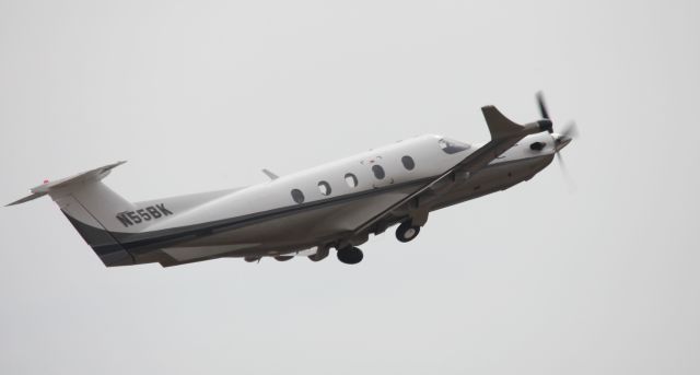 Pilatus PC-12 (N55BK) - Taking off to the west, overcast shies make for a white background