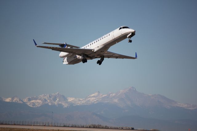 Embraer EMB-145XR (N14117) - Departing runway 8, Longs Peak in the background.