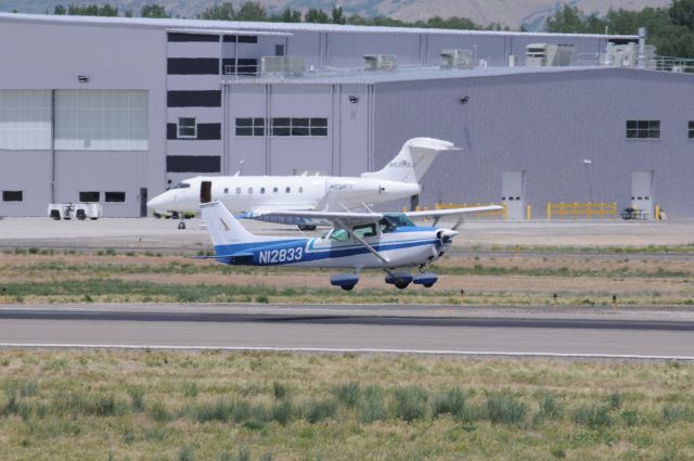 Cessna Skyhawk (N12833) - “Cool blues” skyhawk touching down Runway 13, Provo. br /“XO jet” Challenger (N537XJ) in the background at Duncan. br /Best viewed in full!