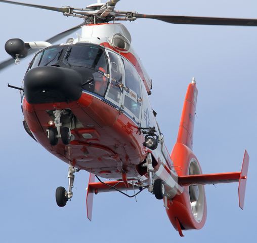 — — - U.S. Coast Guard (Air Station Los Angeles) HH-65 Dolphin helicopter flying over Santa Monica Pier.