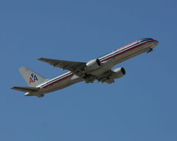 Boeing 757-200 (N712TW) - KLAS - former TWA 757 climbing out at Las Vegas from Runway 7L on a very windy day. This jet climbed quite high before passing the E Sunset Air-park on 3/31/2005.br /br /Serial number 27624 LN:760br /Type 757-2Q8br /First flight date 05/06/1997br / 