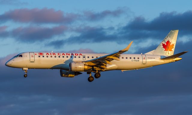 Embraer ERJ-190 (C-FNAW) - Taken Sunday April 8th 2018. A spectacular sunset lights up this AC Embraer on short finals for runway 06L at YYZ