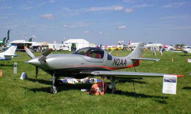 Lancair Legacy 2000 (N2AA) - N2AA is a 2009 Lancair Legacy from Asheville, NC and received the 2010 Champion Kit-Built Award at Oshkosh AirVenture 2010.  Owner (under plane) spent many hours cleaning as shown.