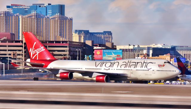 Boeing 747-200 (G-VXLG) - Virgin Atlantic B747-400 "Ruby Tuesday" taxis to the gate at McCarran in Las Vegas, Nevada after a 10-1/2 flight from London Heathrow.br /If you look closely over the top of the plane you can see a billboard for Norwegian Air.  The tall buildings are on the Las Vegas Strip