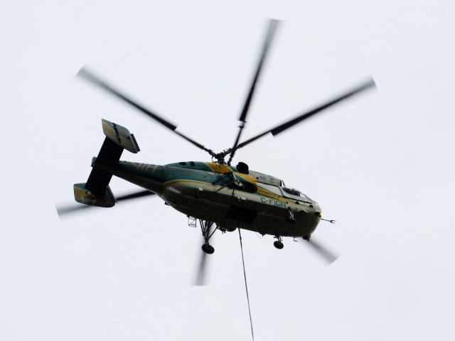 KAMOV Ka-32 (C-FIGR) - C-FIGR, a VIH Kamov 32 hovering in drizzly weather while the crew secures a load during some heavy lift operations. Eric / QNSL mile 137, Québec - August 2013