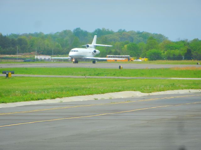 Dassault Falcon 900 (N711FJ) - A Falcon 900 Taxiing To The Runway, A Shuttle bus is visable in the distance, just before the Manassas Airshow 2018 began, we got a surprise! N911FX appeared out of nowhere and tookoff about 5-10 minutes before all normal operations were temporally suspended until the airshow was over!