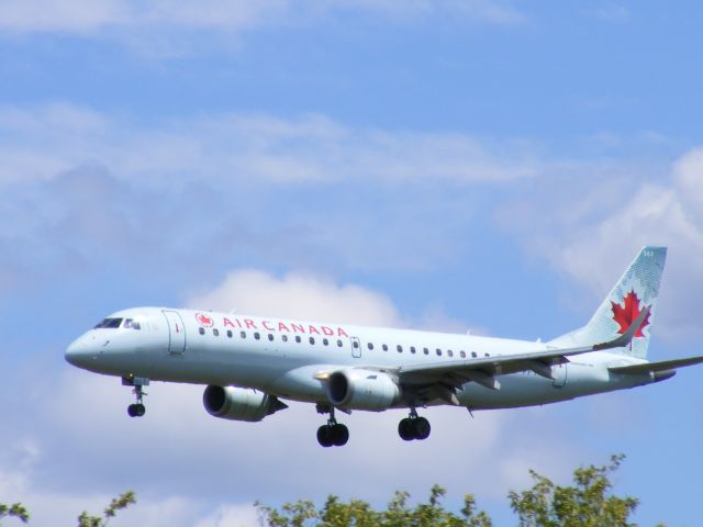 C-FFYM — - clearing the tree tops on approach to #32