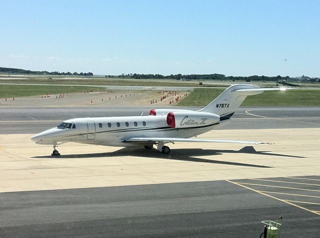 Cessna Citation X (N75TX) - Base operations next to Bravo.  In the background you can see the Ski Jump for JSF.