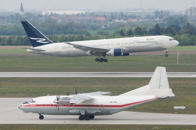 Antonov An-12 (UR-CAK) - N120DL in the background