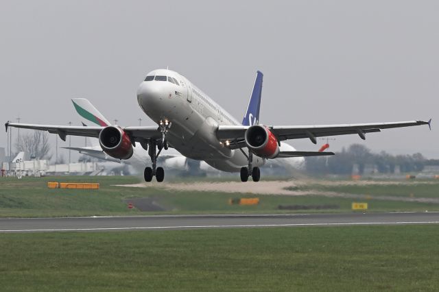 Airbus A320 (OY-KAT) - SAS540 departs to Copenhagen as UAE22 crosses runway 23R in the background.