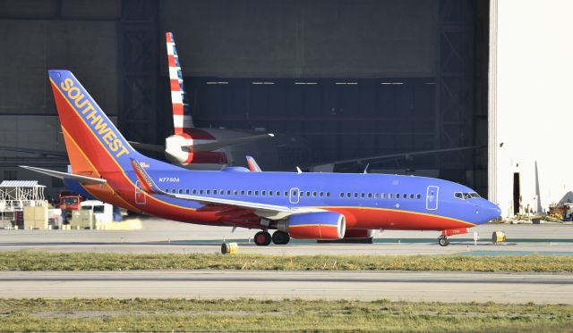 Boeing 737-700 (N7750A) - Taxiing for departure on 25R