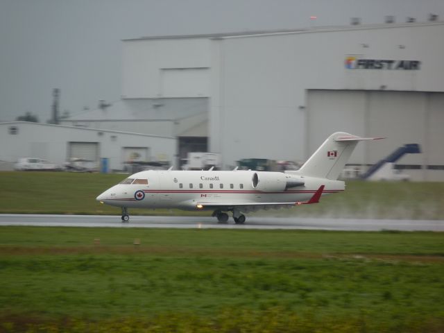 Canadair Challenger (14-4617) - rolling down rwy #25 during a downpour.