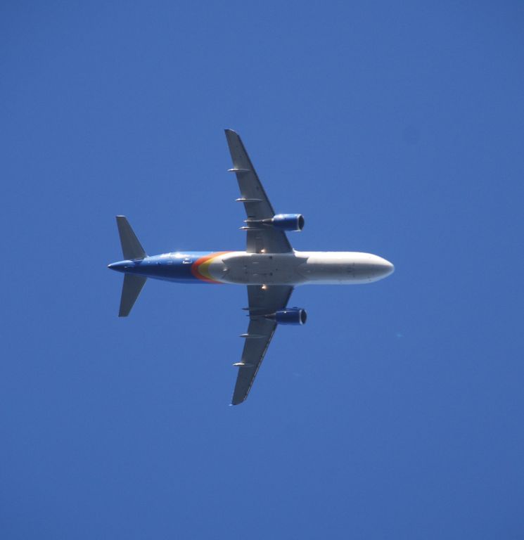 Airbus A320 (N233NV) - Flying directly over my back yard on approach to GSP.