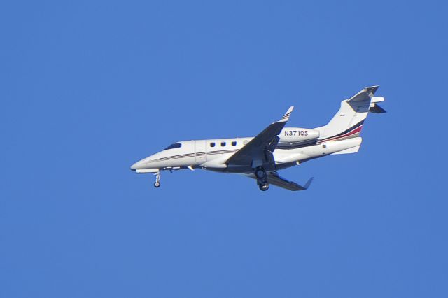 Embraer Phenom 300 (N371QS) - On approach to Moffett Federal Airfield.   As seen from Sunnyvale, California.