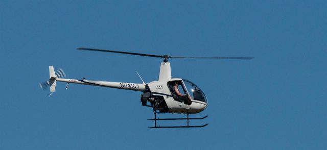 Robinson R-22 (N8416J) - Photographed from parking lot across from Olympia Airport, WA