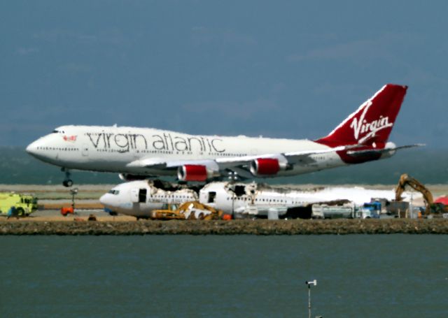 Boeing 777-200 (HL7742) - Asiana Flight 214 July 11, 2013 - NTSB beginning to remove hulk. Virgin Atlantic 747 Flight 19 from London lands on 28R.