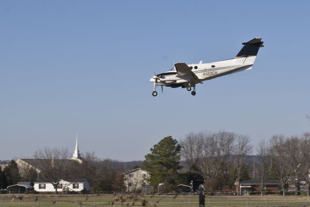 Beechcraft King Air F90 (N123CH) - Standing just outside the airport fence.