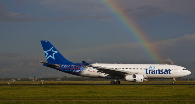 Airbus A330-300 (C-GTSJ) - Air Transat A330 C-GTSJ (welcome livery) being welcomed to Amsterdaam by a rainbow