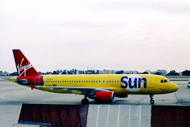 Airbus A320 (G-VKID) - Old memories. Photo of a very rare visitor - Virgin Sun to Athens old Hellinikon Airport (now closed). Shot taken 18 years ago.